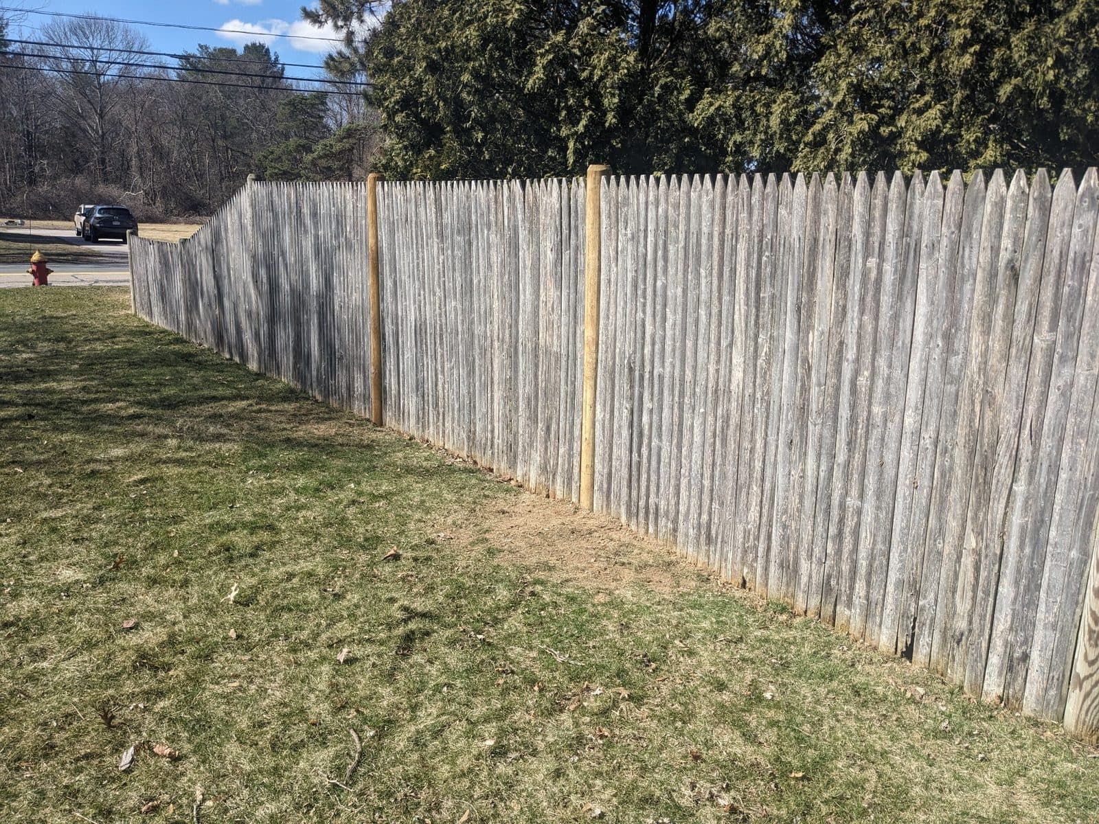 Wood fence restored with new posts after repair
