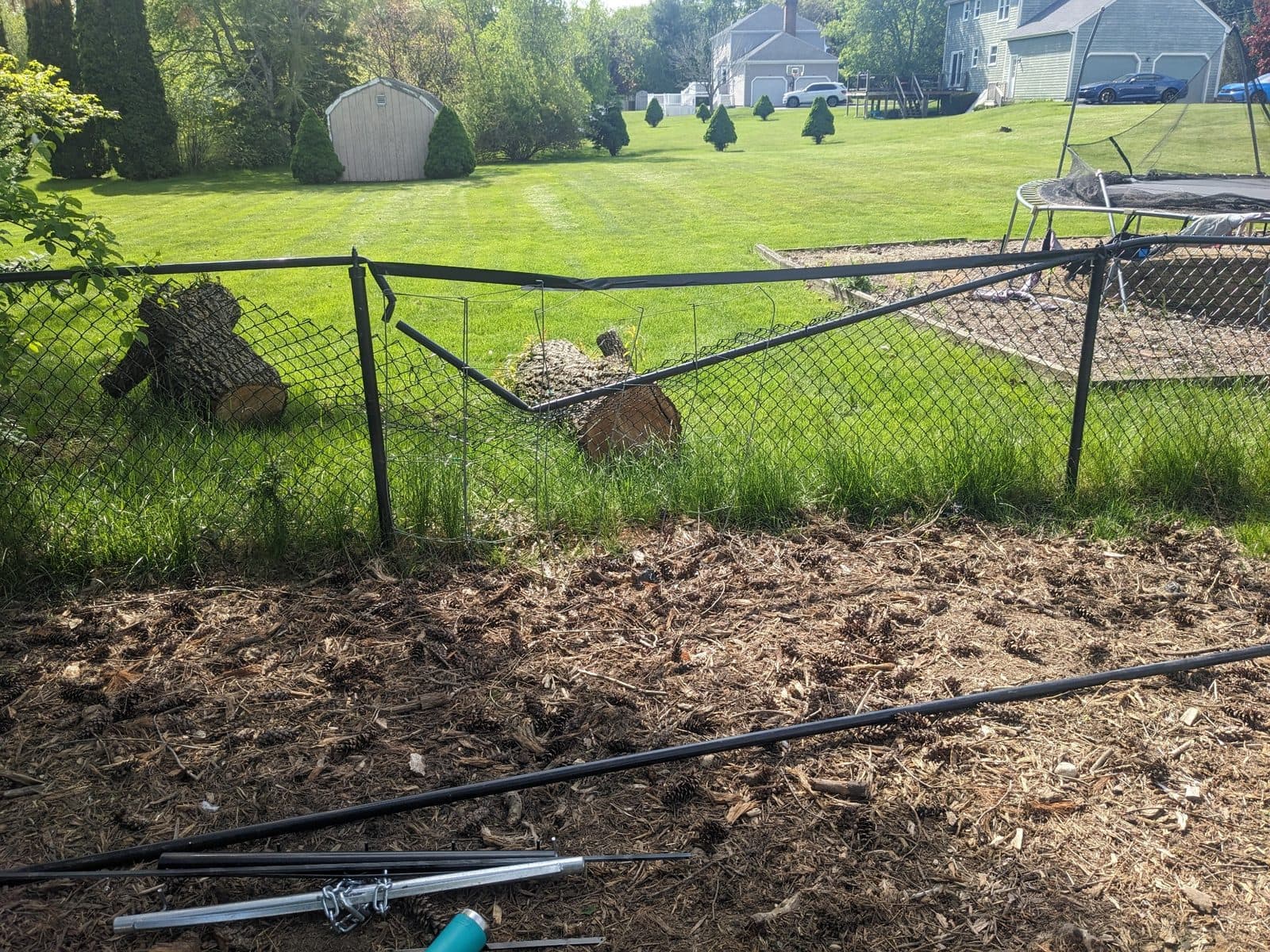 Damaged chain-link fence before repair