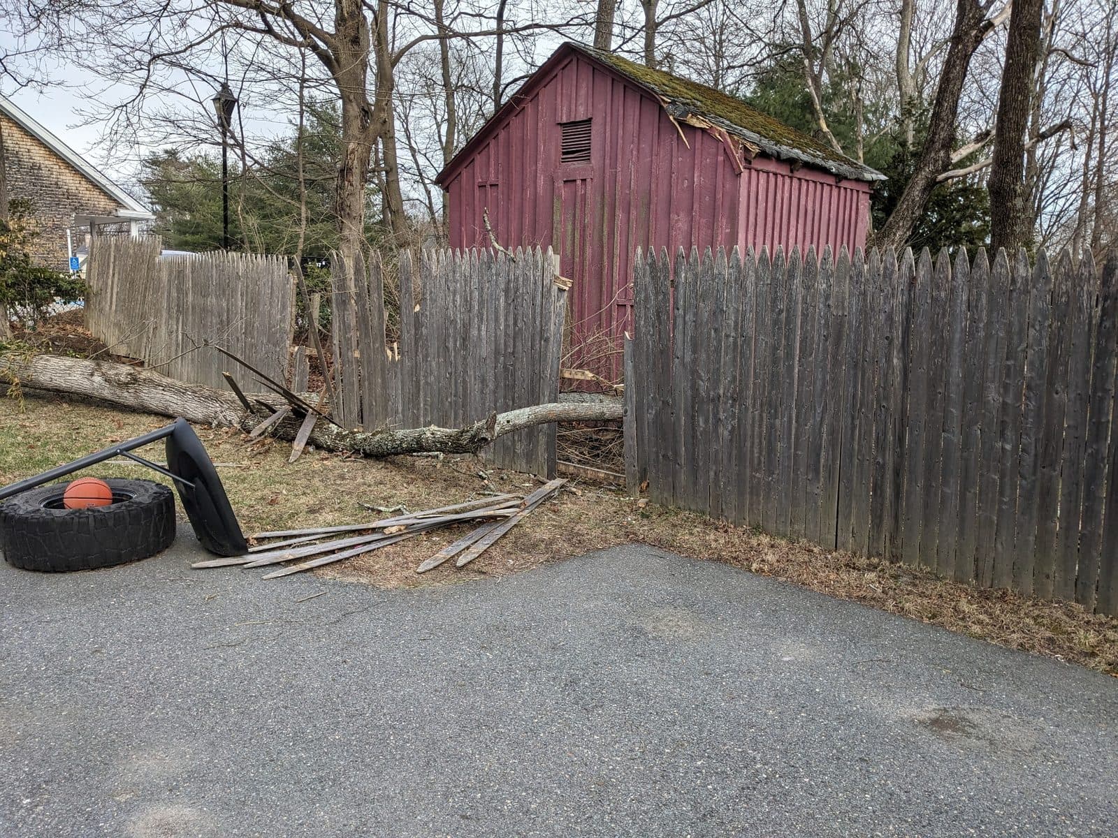 Storm damaged wood fence before repair